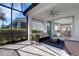 Large covered lanai with comfortable seating and view into open-concept living space at 6255 Cassia St, Bradenton, FL 34203