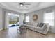 Bright living room features a large sectional sofa and a view to the backyard patio at 6255 Cassia St, Bradenton, FL 34203