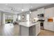 Open concept kitchen and living room with tile floors, island with a breakfast bar, and modern appliances at 6255 Cassia St, Bradenton, FL 34203