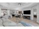 Spacious living room with a tray ceiling, wood-look tile floors, and access to the kitchen and dining area at 6255 Cassia St, Bradenton, FL 34203