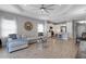 Open-concept living room with a large sofa, dining table, and a view into the modern kitchen at 6255 Cassia St, Bradenton, FL 34203