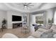 Bright living room with a ceiling fan, comfortable seating, and sliding glass doors to the outdoor area at 6255 Cassia St, Bradenton, FL 34203