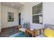 Covered front porch with seating area and blue door at 6255 Cassia St, Bradenton, FL 34203