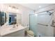 Well-lit bathroom featuring a shower with glass door, vanity with sink, toilet, and updated fixtures at 6407 Quail Hollow Pl, Bradenton, FL 34210