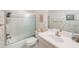 Bathroom with shower and tub, sink, toilet, and decorative wallpaper, plus a framed artwork at 6407 Quail Hollow Pl, Bradenton, FL 34210
