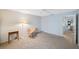 Bedroom with carpet flooring, side tables, accent chair, and a view to the bedroom across the hall at 6407 Quail Hollow Pl, Bradenton, FL 34210