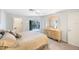 Bright bedroom featuring carpet flooring, a ceiling fan, and French doors leading to the outdoor area at 6407 Quail Hollow Pl, Bradenton, FL 34210