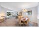 Open-concept dining and living area, with natural light and neutral color palette at 6407 Quail Hollow Pl, Bradenton, FL 34210