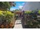 Beautiful gated entrance with lush landscaping leading to the front door at 6407 Quail Hollow Pl, Bradenton, FL 34210