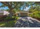 Charming single-Gathering home featuring a two-car garage and mature trees shading the front yard at 6407 Quail Hollow Pl, Bradenton, FL 34210