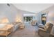 Bright and airy living room featuring neutral carpeting and view to the lanai at 6407 Quail Hollow Pl, Bradenton, FL 34210