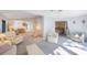 Bright living room featuring neutral carpeting with access to dining area and bedroom at 6407 Quail Hollow Pl, Bradenton, FL 34210