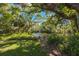 A serene pond creates a tranquil and picturesque view, surrounded by lush greenery and mature trees at 6407 Quail Hollow Pl, Bradenton, FL 34210