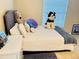 Bedroom with a teddy bear, husky and other cute plush animals placed on the bed at 7114 Hamilton Park Blvd, Tampa, FL 33615