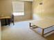 Bedroom features neutral walls, carpeted floors, desk, and a window with blinds at 7114 Hamilton Park Blvd, Tampa, FL 33615