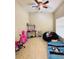 A bedroom or playroom features a ceiling fan and a variety of furniture and decor at 7114 Hamilton Park Blvd, Tampa, FL 33615