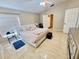 Spacious bedroom with a plush bed, tile floors, and an open layout leading to other areas of the home at 7114 Hamilton Park Blvd, Tampa, FL 33615