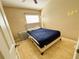 Cozy bedroom with neutral tones, a window for natural light, and tiled flooring for easy maintenance at 7114 Hamilton Park Blvd, Tampa, FL 33615