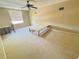 Bedroom featuring neutral walls, carpeted floors, a ceiling fan, and a window with blinds at 7114 Hamilton Park Blvd, Tampa, FL 33615