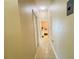 Hallway featuring ceramic tile and neutral colored walls leading to a bedroom at the end of the hall at 7114 Hamilton Park Blvd, Tampa, FL 33615