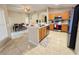 Open-concept kitchen with a central island, stainless steel appliances, and a seamless flow to the dining area at 7114 Hamilton Park Blvd, Tampa, FL 33615