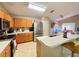 Well-lit kitchen with stainless steel appliances, wooden cabinetry, and a convenient breakfast bar area at 7114 Hamilton Park Blvd, Tampa, FL 33615