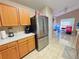 Bright kitchen featuring stainless steel refrigerator, light countertops, and tile flooring at 7114 Hamilton Park Blvd, Tampa, FL 33615