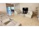 Large living space featuring tile flooring, neutral walls, and a seamless flow to the dining area at 7114 Hamilton Park Blvd, Tampa, FL 33615