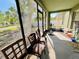 Enclosed porch with chairs, an exercise bike, and views of the backyard at 7114 Hamilton Park Blvd, Tampa, FL 33615