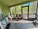 Enclosed porch with chairs, an exercise bike, and views of the backyard at 7114 Hamilton Park Blvd, Tampa, FL 33615
