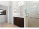 Modern bathroom featuring a dark wood vanity, tiled walk-in shower, and accessible handrails at 7159 Westhill Ct, Lakewood Ranch, FL 34202