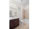 Bathroom features a single vanity, tile flooring, and a shower-tub combo at 7159 Westhill Ct, Lakewood Ranch, FL 34202