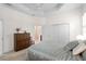 Bright bedroom with tray ceilings, a patterned duvet, and ensuite bathroom access at 7159 Westhill Ct, Lakewood Ranch, FL 34202