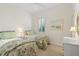 Bedroom features two twin beds, a shuttered window, and neutral decor at 7159 Westhill Ct, Lakewood Ranch, FL 34202