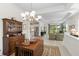 Dining room with view to kitchen, living room, and chandelier at 7159 Westhill Ct, Lakewood Ranch, FL 34202