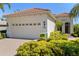Charming home featuring a two-car garage, lush landscaping, and a beautifully tiled roof at 7159 Westhill Ct, Lakewood Ranch, FL 34202