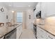 Gourmet kitchen features granite counters, stainless appliances, and white cabinetry at 7159 Westhill Ct, Lakewood Ranch, FL 34202