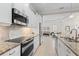 Updated kitchen with granite counters, stainless appliances, and breakfast bar at 7159 Westhill Ct, Lakewood Ranch, FL 34202