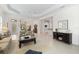Well-lit living room with tile floors, tray ceilings, and a view into the kitchen and dining room at 7159 Westhill Ct, Lakewood Ranch, FL 34202
