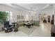 Spacious living room with tile floors, tray ceilings, and access to the dining room and entry way at 7159 Westhill Ct, Lakewood Ranch, FL 34202