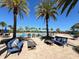 Inviting pool area with palm trees, lounge seating, and comfortable outdoor furniture at 7159 Westhill Ct, Lakewood Ranch, FL 34202