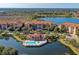 Aerial view of waterfront condos, community pool, and lush landscaping in a desirable location at 7710 Lake Vista Ct # 407, Lakewood Ranch, FL 34202
