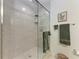 This bathroom features a glass shower with a tiled surround, a towel rack, and neutral decor at 7710 Lake Vista Ct # 407, Lakewood Ranch, FL 34202