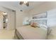 This bedroom has neutral decor, a ceiling fan, and calming wall art for a serene retreat at 7710 Lake Vista Ct # 407, Lakewood Ranch, FL 34202