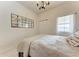 Bedroom featuring a grid-style mirror, a neutral comforter, and a bedside table lamp at 7710 Lake Vista Ct # 407, Lakewood Ranch, FL 34202
