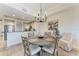 Dining area with a round table and seating for four, with a view of the kitchen at 7710 Lake Vista Ct # 407, Lakewood Ranch, FL 34202