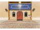 Attractive building facade with arched entryway, decorative tilework, and classic sconces at 7710 Lake Vista Ct # 407, Lakewood Ranch, FL 34202