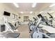 Well-equipped fitness center with a variety of exercise machines and natural light at 7710 Lake Vista Ct # 407, Lakewood Ranch, FL 34202