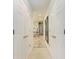 Hallway leading to the main bathroom with marble walk-in shower at 7710 Lake Vista Ct # 407, Lakewood Ranch, FL 34202