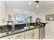 Kitchen featuring black countertop bar with a view of the living room at 7710 Lake Vista Ct # 407, Lakewood Ranch, FL 34202